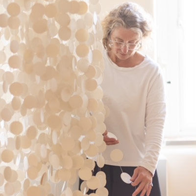 Sue Paraskeva setting up hanging display